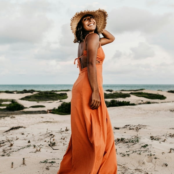 a person throwing a frisbee at the beach