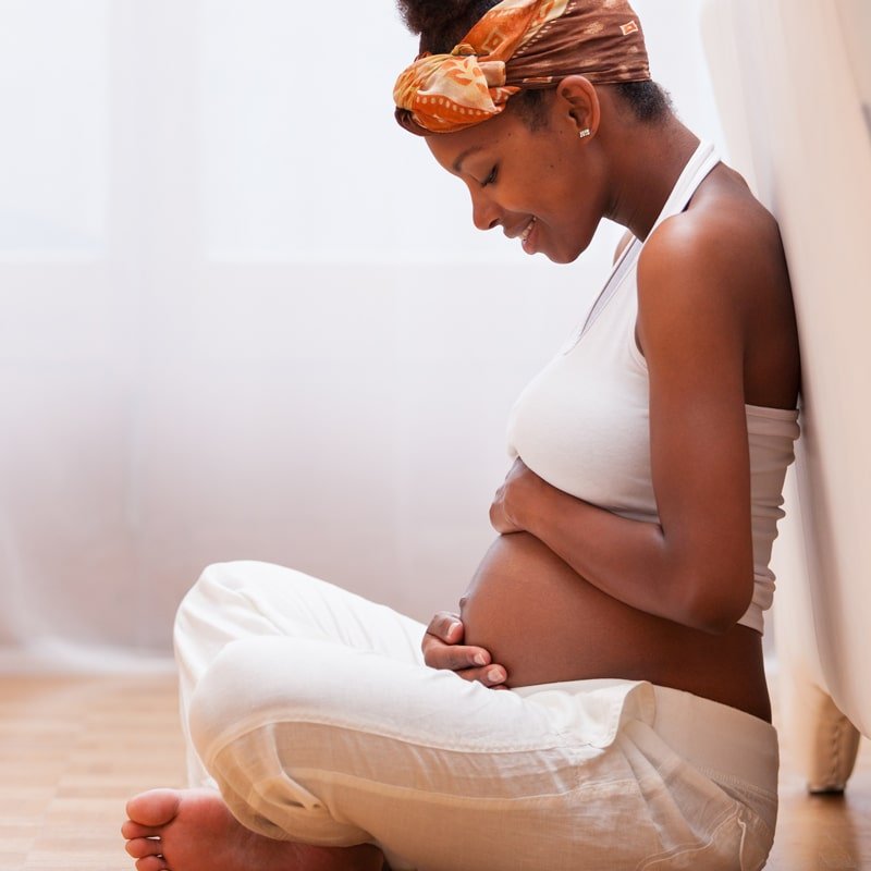 a woman sitting on a bed